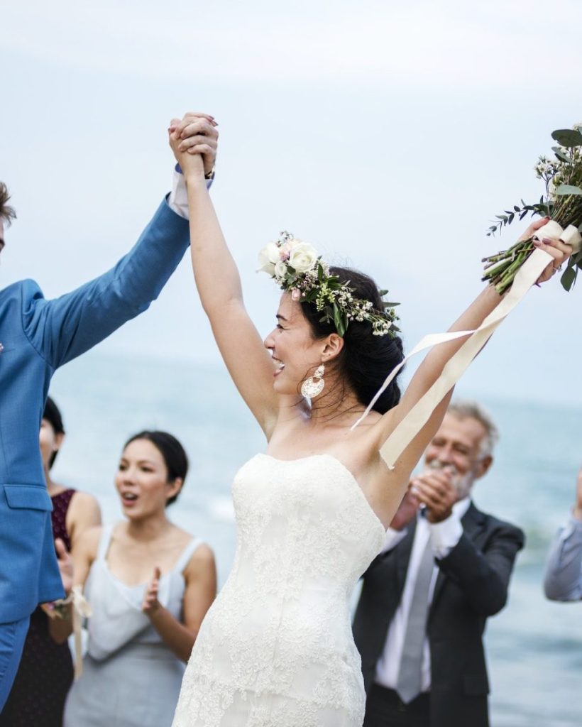 young-couple-in-a-wedding-ceremony-at-the-beach-1-e1630318349114.jpg